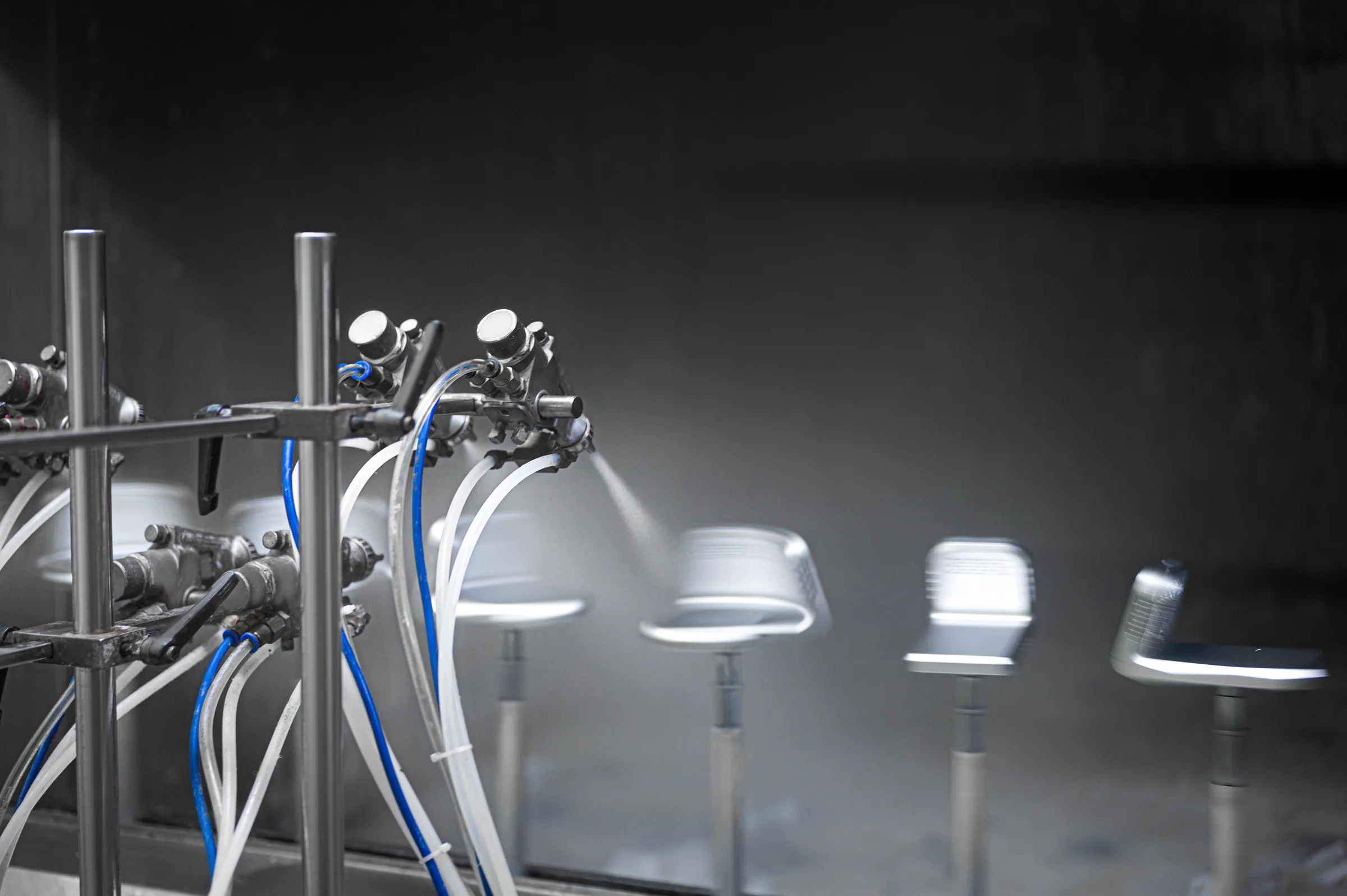 Metal components moving through a controlled coating process